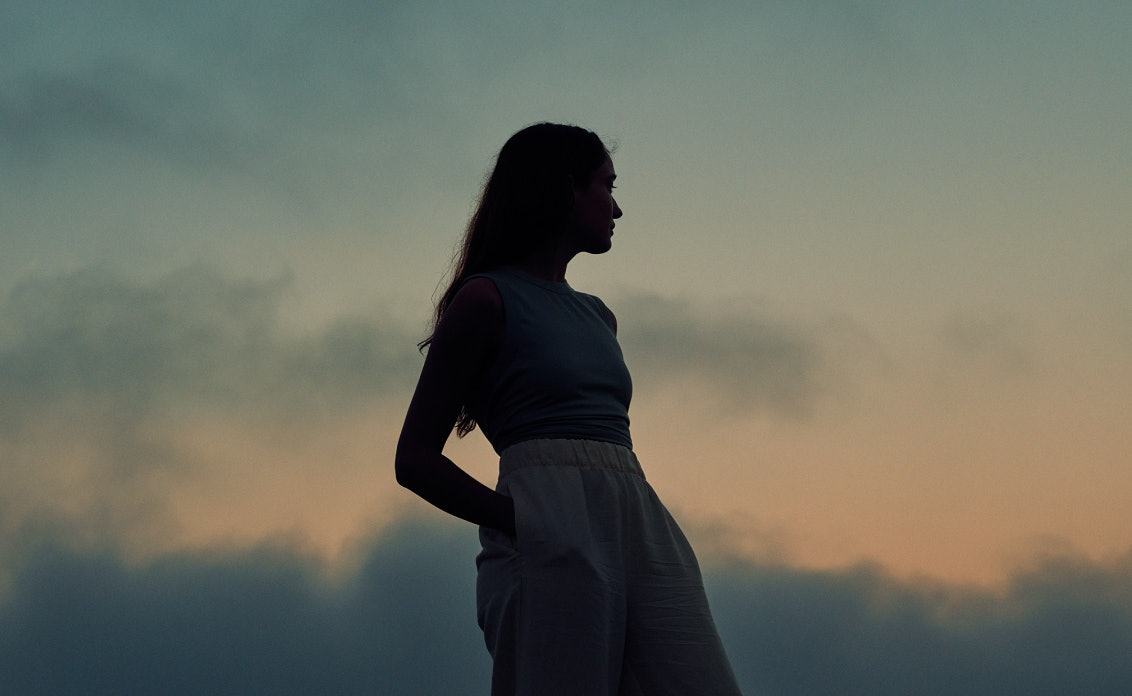 Picture of a person in a medical coat smiling