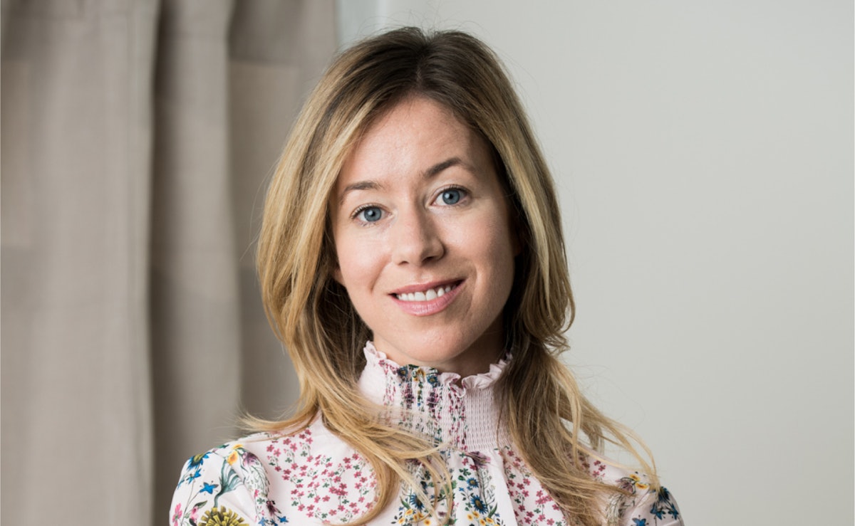Picture of a person in a medical coat smiling
