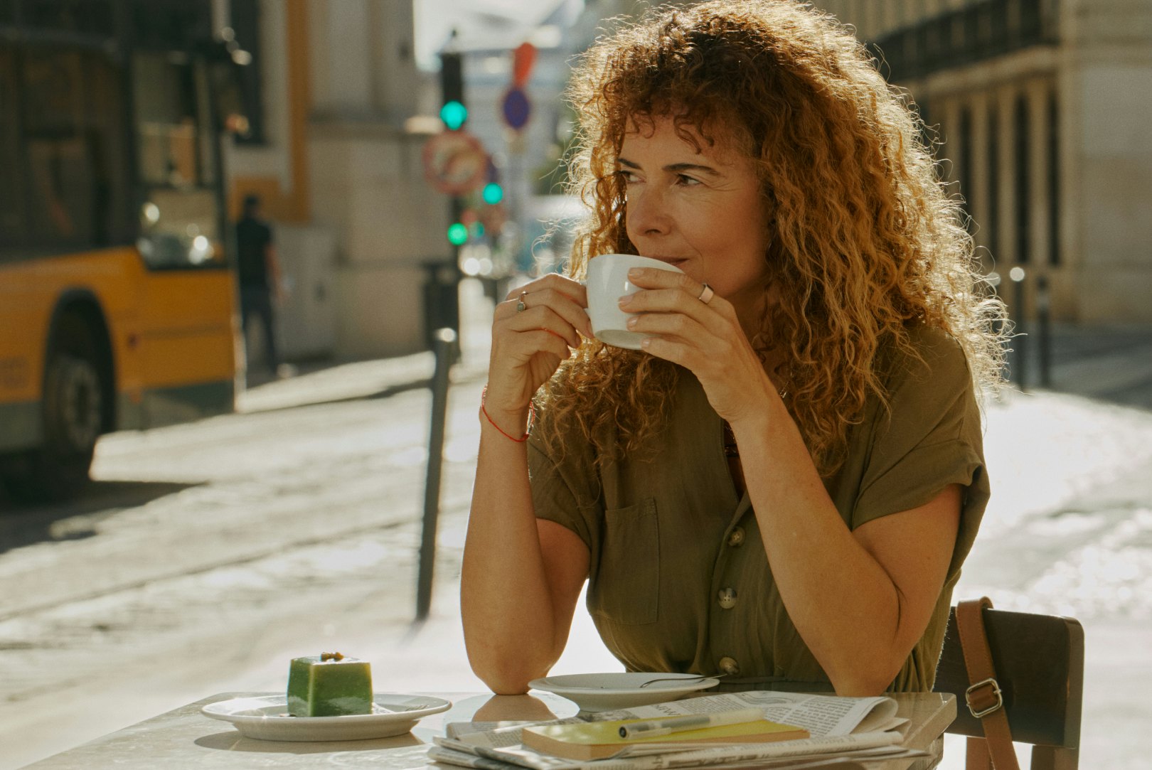Woman enjoying a hot beverage at a cafe
