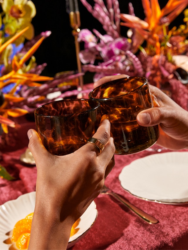 Cheers with beverages while wearing Oura rings