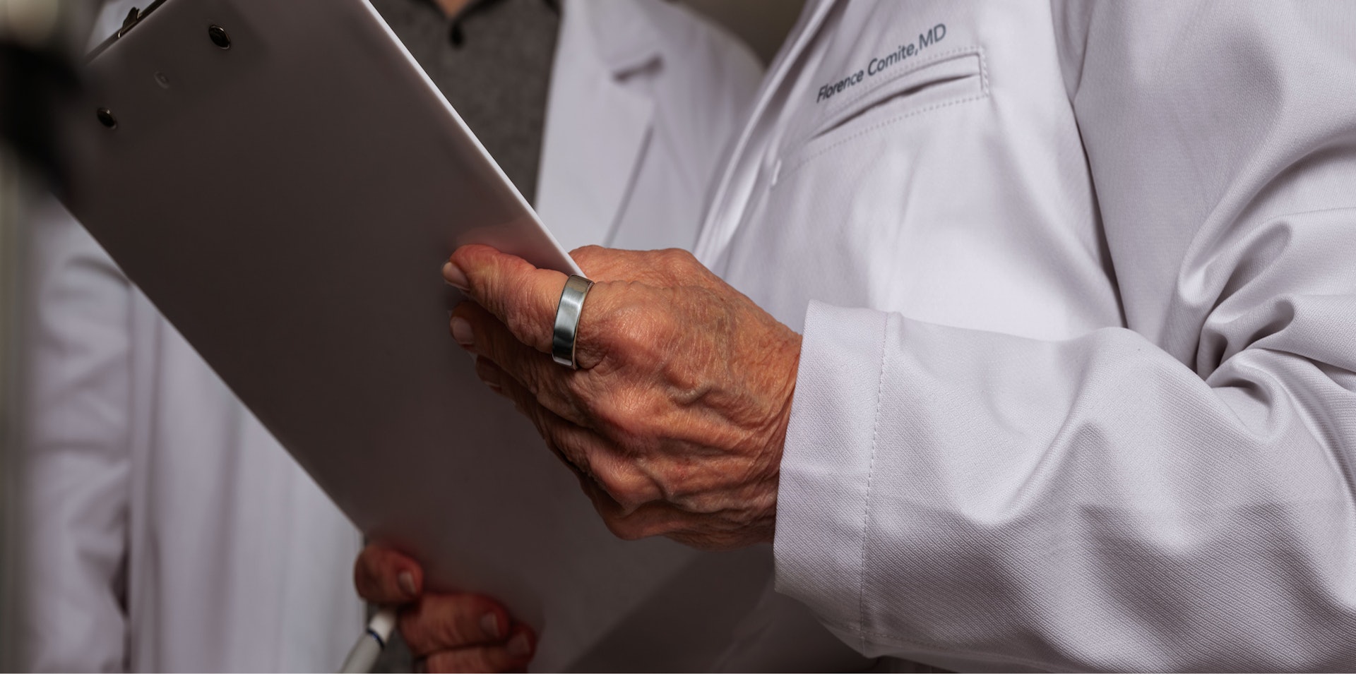 M.D. in a lab coat reviewing data