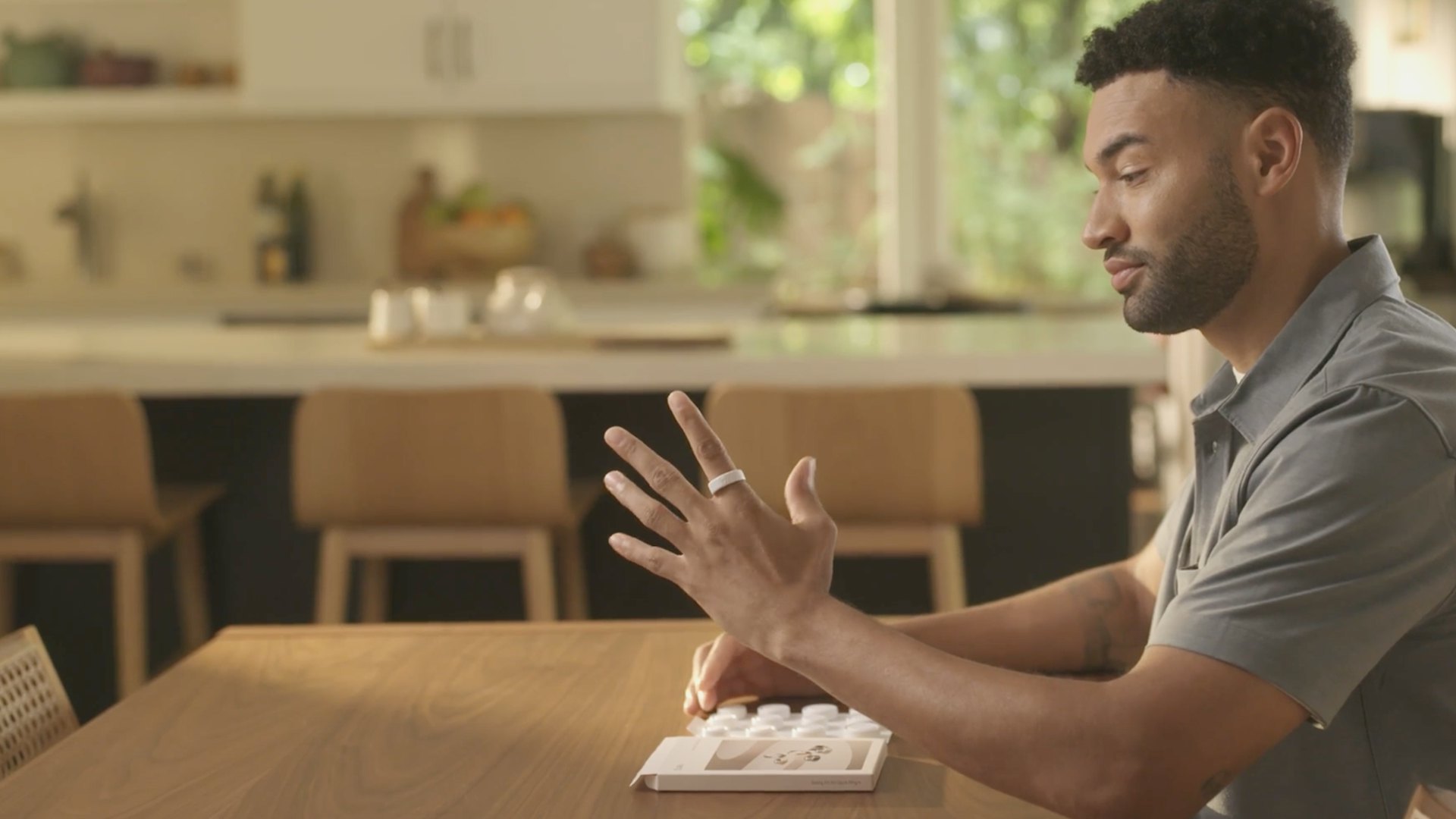 A man uses a sizing kit to determine his Oura Ring size