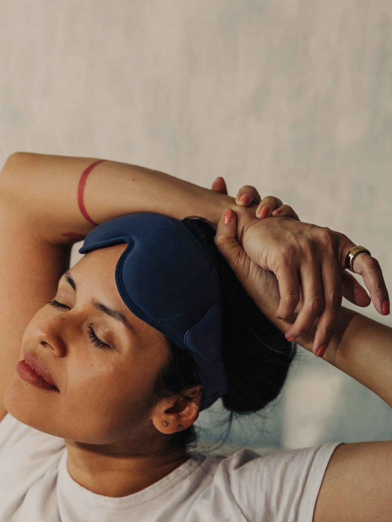 Woman reading a book wearing an Oura ring.