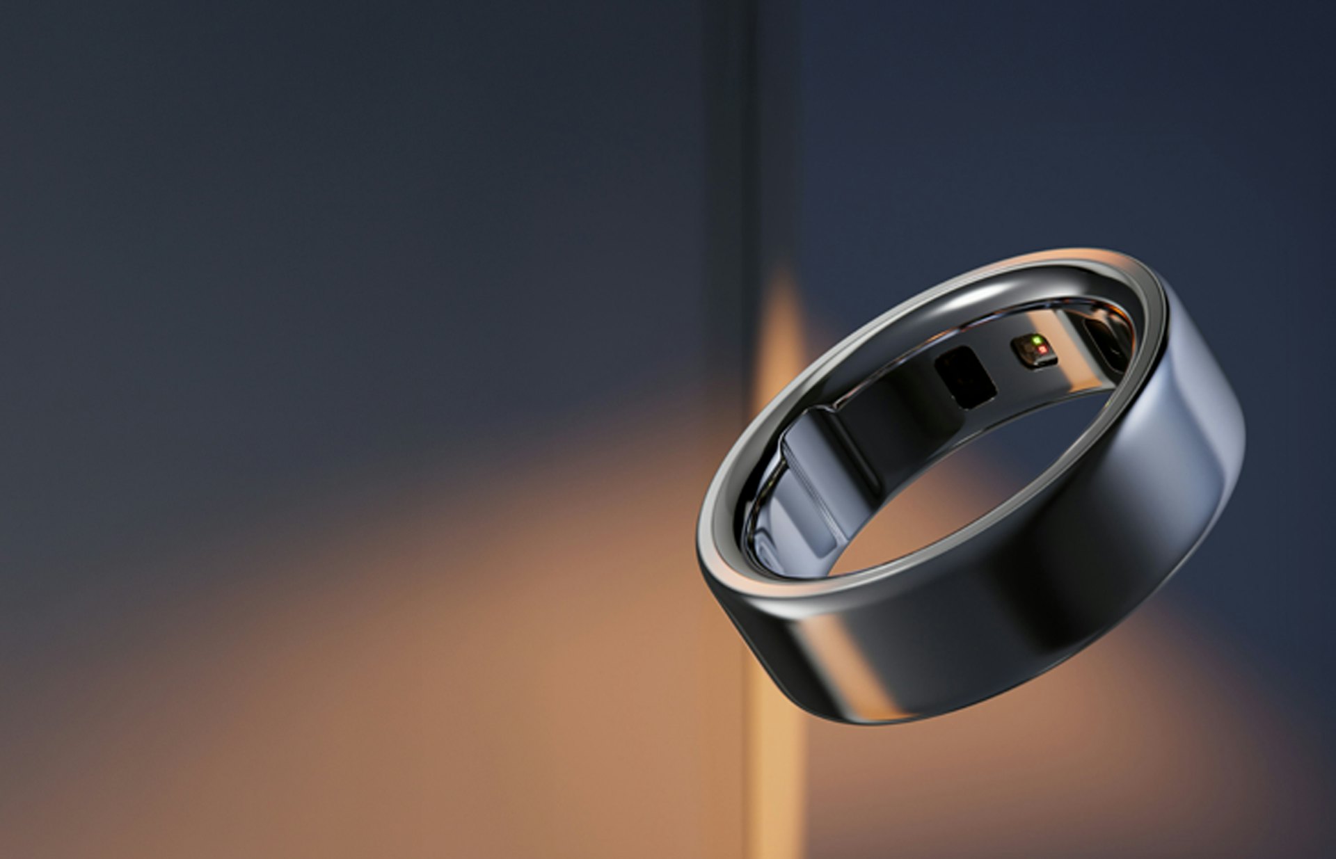 An Oura Ring 4 against a dark blue and soft orange background